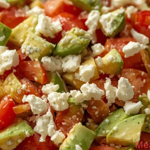 Fresh avocado tomato feta salad in a white bowl with diced avocado, small tomato pieces, and crumbled feta cheese, keto-friendly and low-carb.