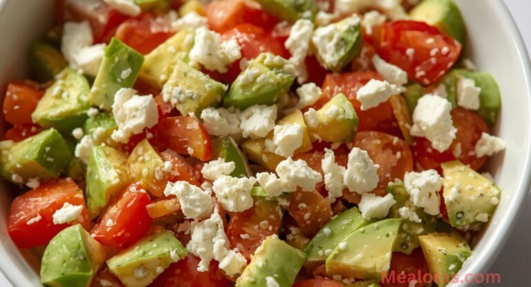 Fresh avocado tomato feta salad in a white bowl with diced avocado, small tomato pieces, and crumbled feta cheese, keto-friendly and low-carb.