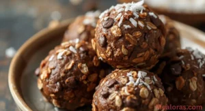 no-bake Moose Farts chocolate and coconut balls on a white platter, showing chewy texture and cocoa coating