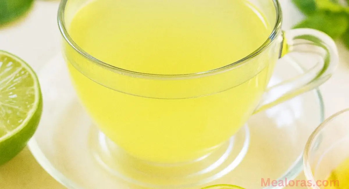 steaming cup of lemon balm tea with fresh lemon and honey on the side, showcasing a healthy weight loss drink