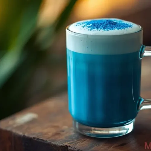Pouring blue salt trick drink into mug with mint garnish ready to serve warm or chilled