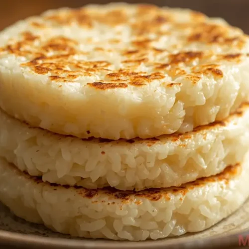 Soft and chewy South Asian rice cakes served on a plate, traditional steamed pitha