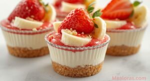 Strawberry Cheesecake Banana Pudding layered dessert with fresh strawberries, sliced bananas, and creamy cheesecake layer