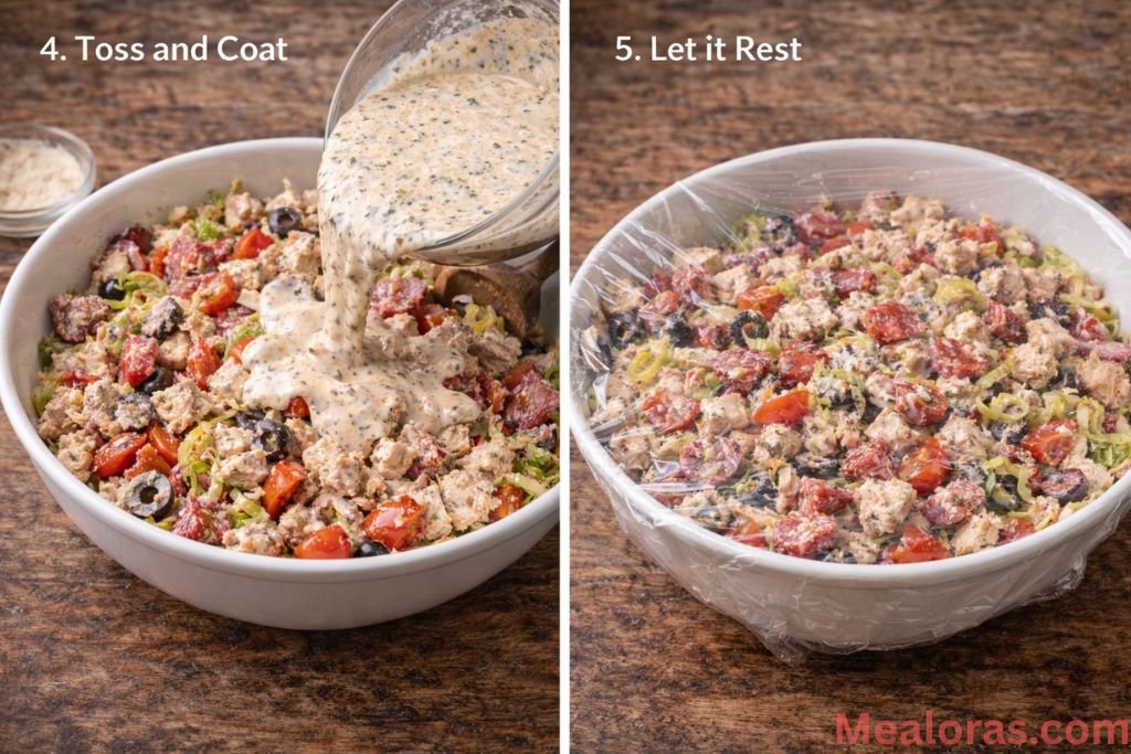 A spatula folding the creamy dressing into a large bowl of chicken, meats, and vegetables until everything is evenly coated