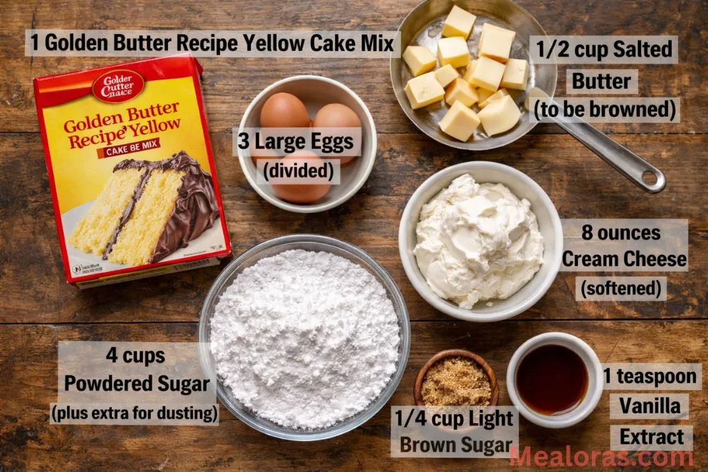 Cake mix, cream cheese, butter, eggs, and sugar arranged on a counter