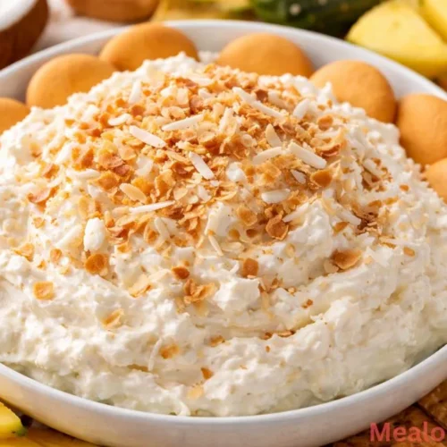 Coconut Cream Pie Dip in a bowl with toasted coconut garnish
