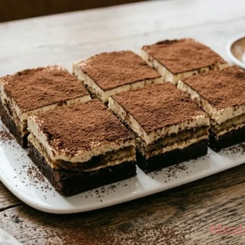shot of a sliced Tiramisu Brownie showing layers of chocolate, ladyfingers, and mascarpone cream